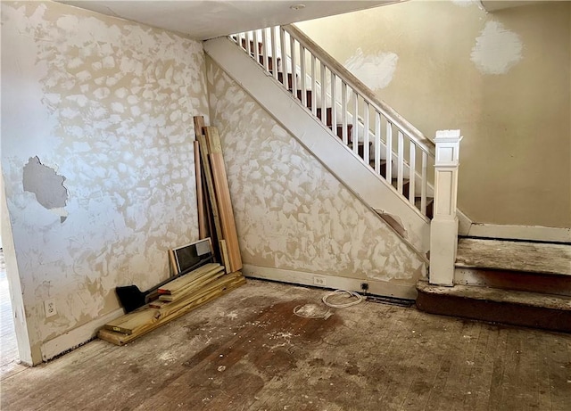 stairs with wallpapered walls