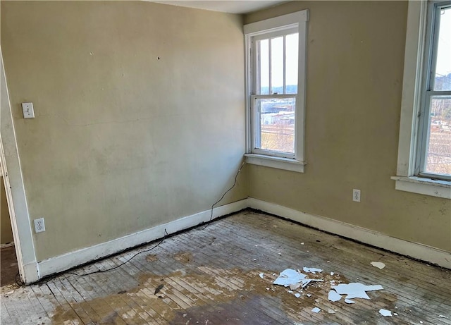 spare room with a wealth of natural light and baseboards