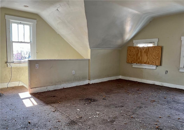 additional living space featuring vaulted ceiling