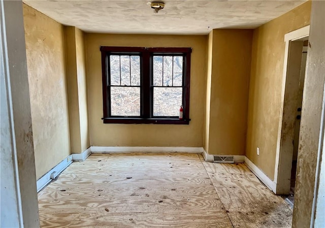 empty room featuring baseboards