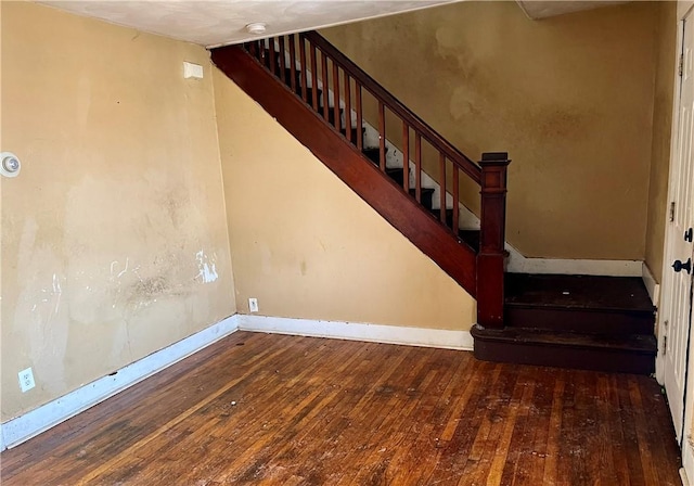 stairs featuring hardwood / wood-style flooring and baseboards