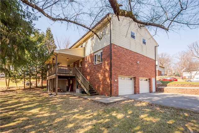 view of home's exterior featuring aphalt driveway, stairway, a garage, and brick siding