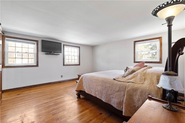 bedroom with baseboards and light wood-style floors