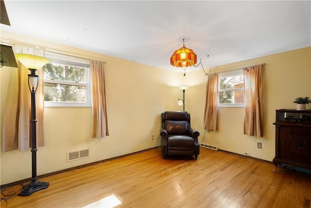 unfurnished room with visible vents and wood finished floors