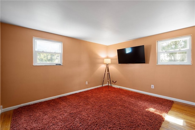 unfurnished room with baseboards