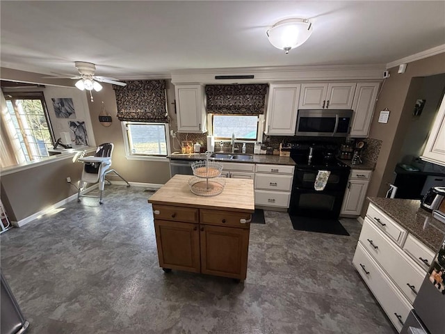 kitchen with a sink, stainless steel microwave, double oven range, decorative backsplash, and baseboards