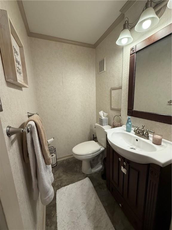 half bath with vanity, toilet, visible vents, and ornamental molding