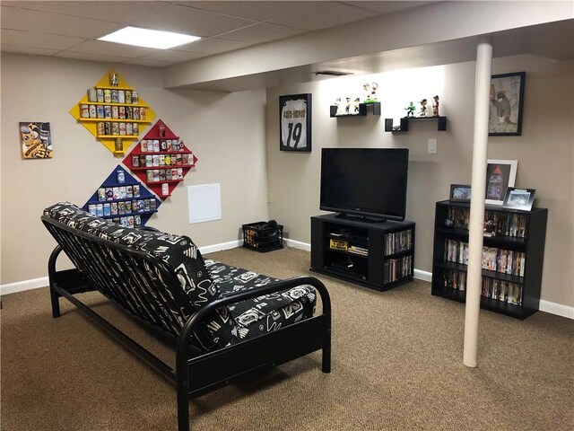 living area with a paneled ceiling, baseboards, and carpet floors