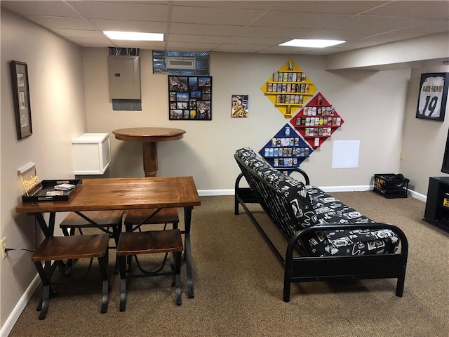 recreation room with electric panel, carpet, baseboards, and a paneled ceiling