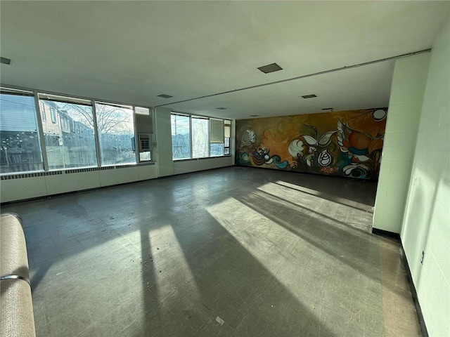 unfurnished living room featuring tile patterned floors and visible vents