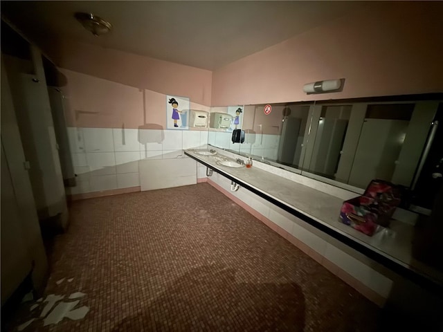 bathroom featuring vaulted ceiling and a sink