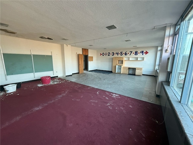 miscellaneous room with visible vents and a textured ceiling