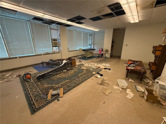 interior space with a paneled ceiling