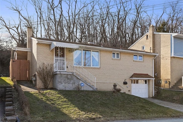 view of front of property featuring a front yard, driveway, an attached garage, a chimney, and brick siding