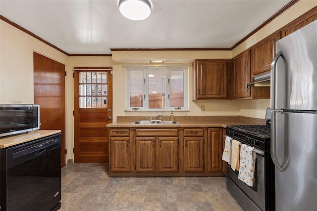 kitchen featuring crown molding, brown cabinets, appliances with stainless steel finishes, and a sink