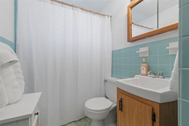 bathroom with vanity, tile walls, toilet, and a shower with curtain