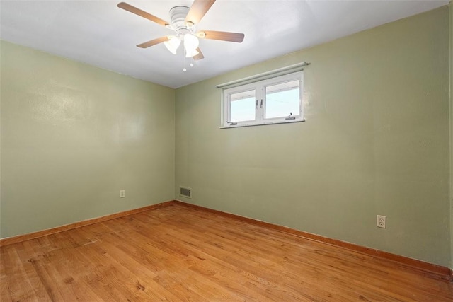 unfurnished room featuring visible vents, baseboards, light wood-style floors, and a ceiling fan