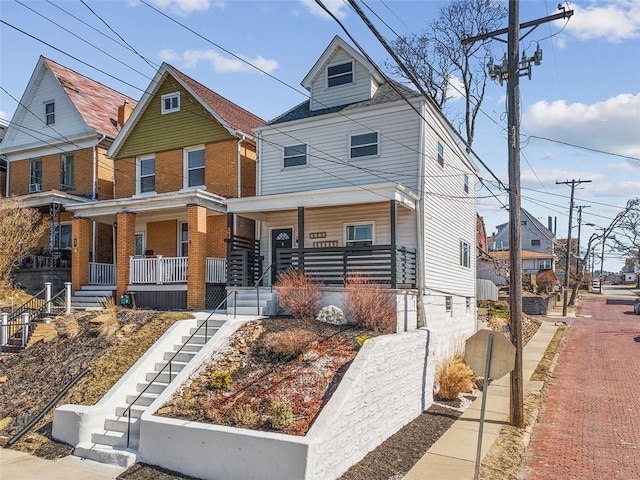 view of front of property featuring a porch and stairs