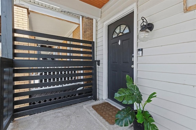 doorway to property with brick siding