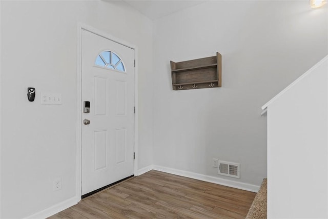 entryway featuring wood finished floors, visible vents, and baseboards