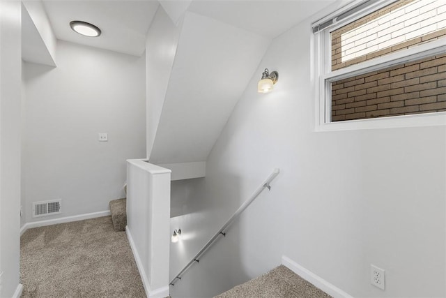 stairs featuring visible vents, carpet floors, and baseboards