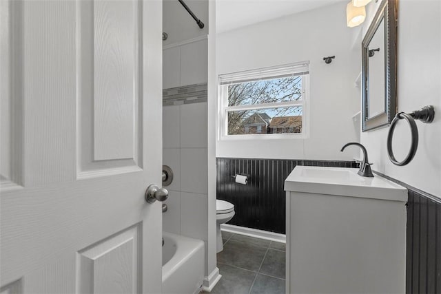 bathroom featuring tile patterned flooring, bathing tub / shower combination, toilet, and vanity