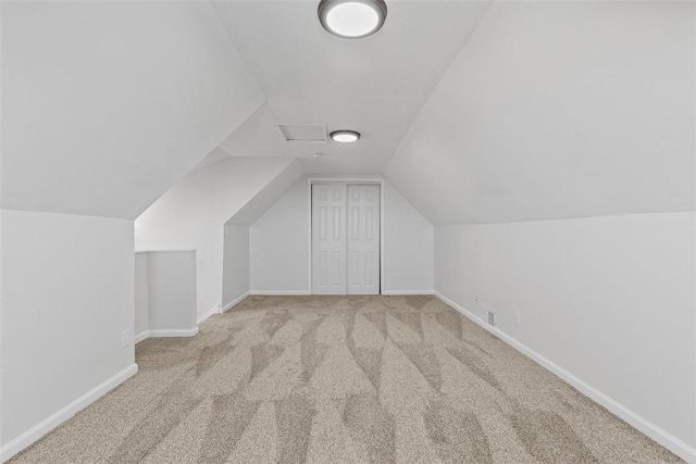 bonus room with vaulted ceiling, carpet, and baseboards