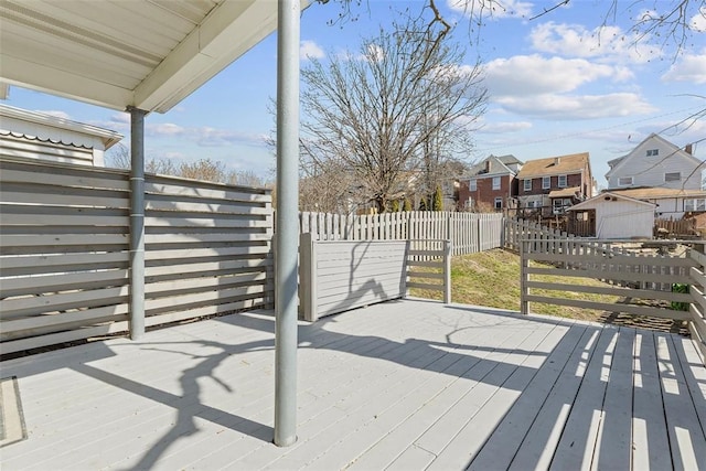 wooden terrace featuring a residential view and fence