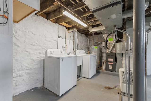 unfinished below grade area featuring gas water heater and washer and clothes dryer