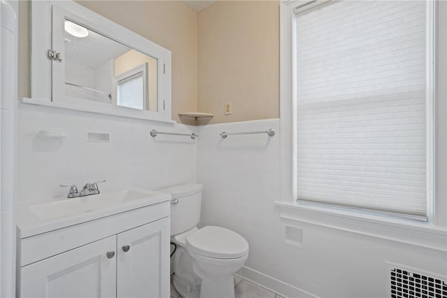 bathroom featuring toilet, radiator heating unit, and vanity