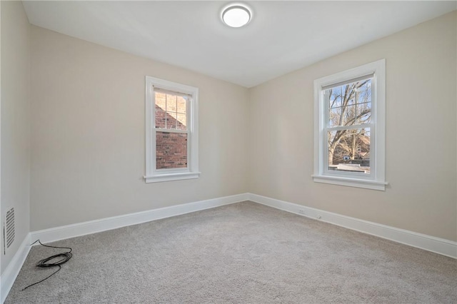 unfurnished room with carpet flooring and baseboards