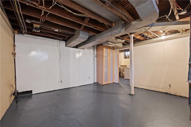 unfinished basement featuring separate washer and dryer