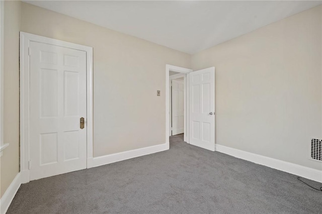 unfurnished bedroom featuring baseboards and carpet floors