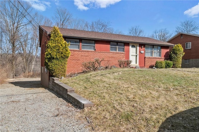 ranch-style home with brick siding and a front yard