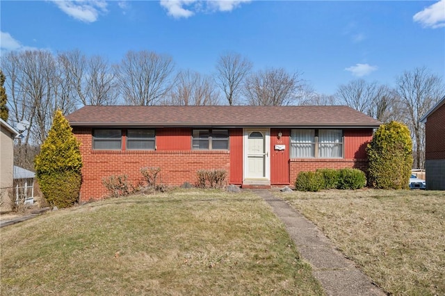 single story home with brick siding, a front lawn, and a shingled roof