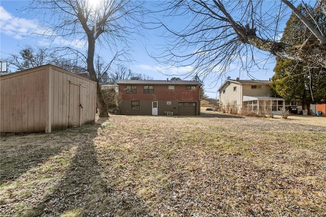 view of yard with a storage unit, a garage, and an outdoor structure