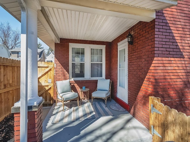 view of patio / terrace with fence and covered porch