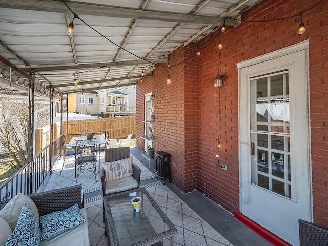 view of patio / terrace featuring outdoor dining area and fence