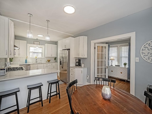 dining space with light wood-type flooring