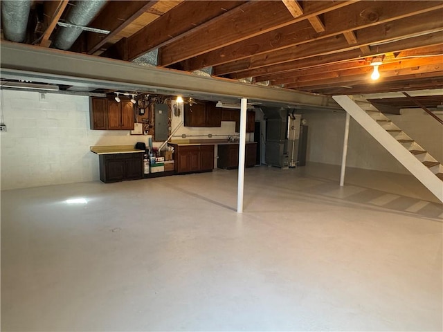 unfinished basement featuring electric panel, heating unit, and stairs