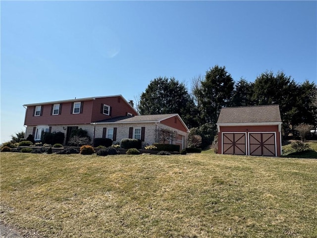 view of front of home with an outbuilding and a front lawn