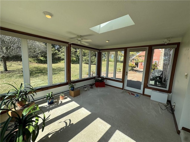 sunroom / solarium with a healthy amount of sunlight and a skylight