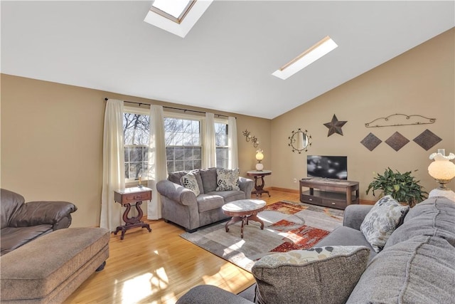 living area with light wood-type flooring and lofted ceiling with skylight