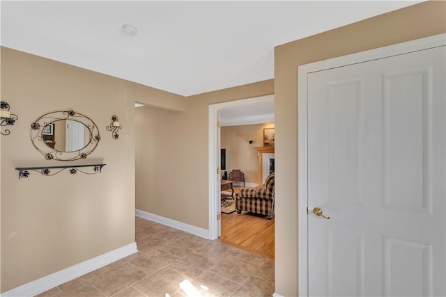 hall with light tile patterned floors and baseboards