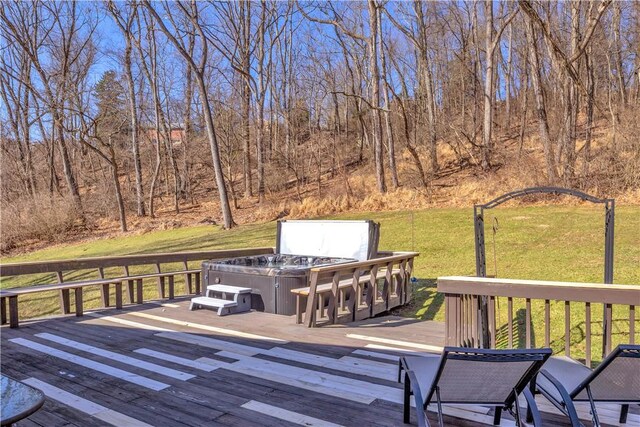 wooden deck featuring a view of trees and a lawn