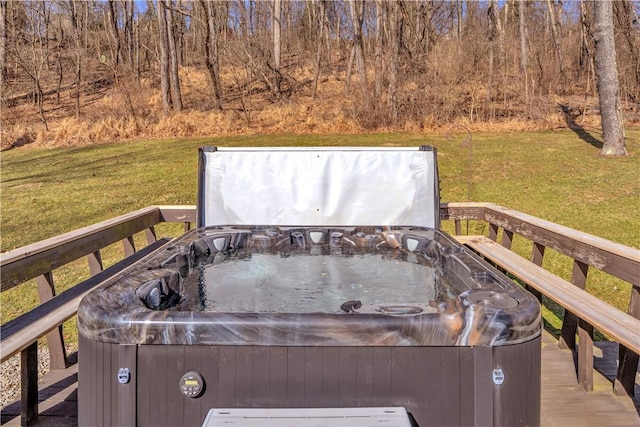 wooden deck with a lawn and a hot tub