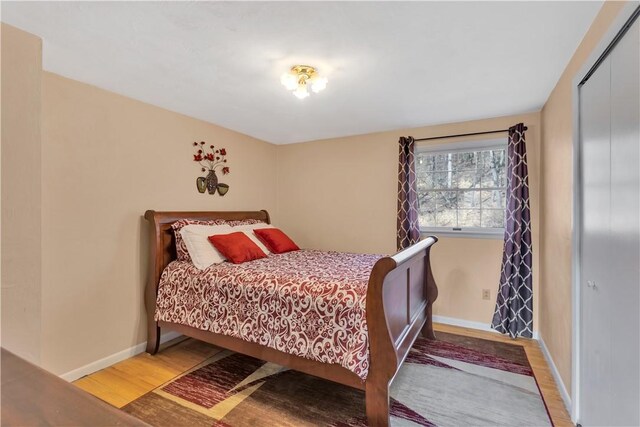 bedroom featuring wood finished floors and baseboards