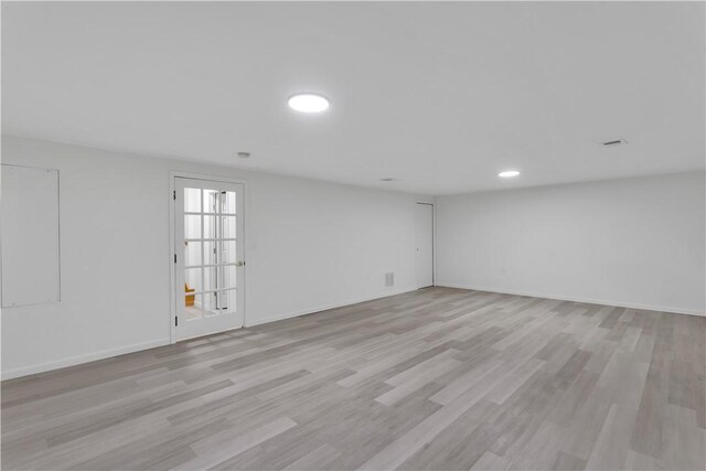 empty room featuring light wood finished floors and baseboards