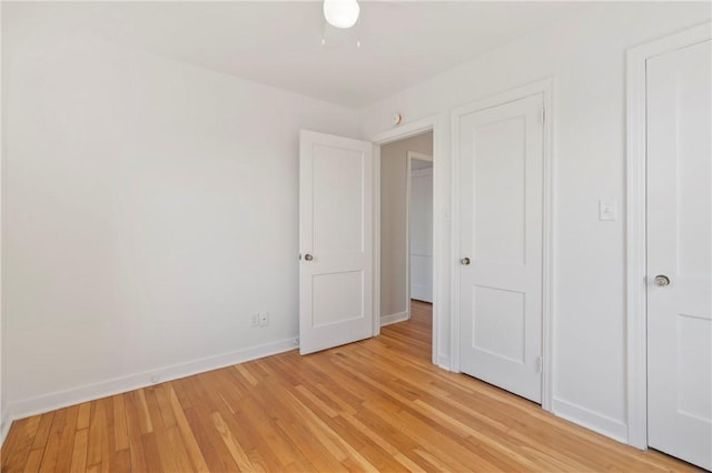 unfurnished bedroom featuring light wood-style flooring and baseboards