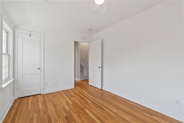 unfurnished bedroom featuring light wood-style flooring and baseboards